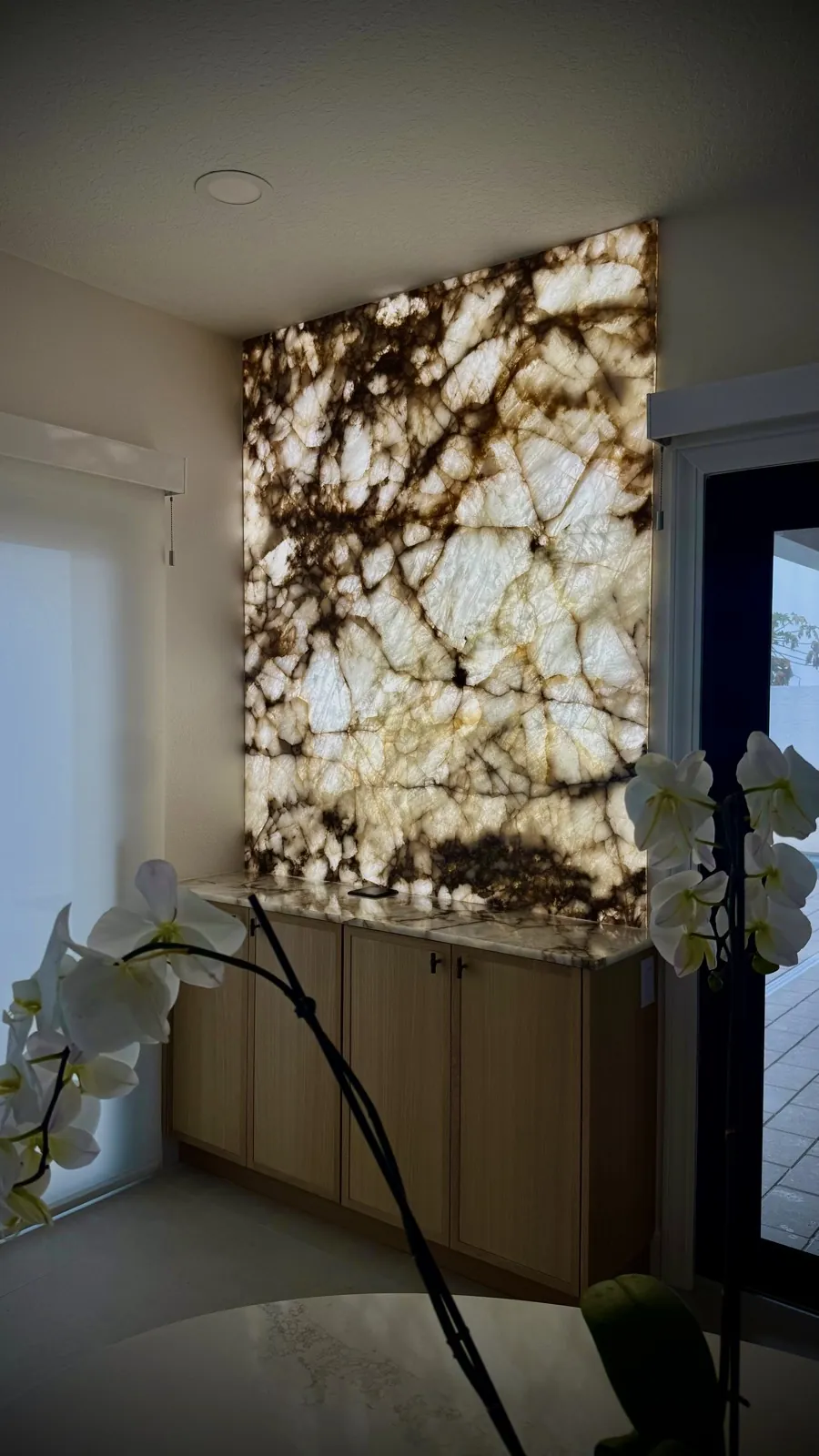 Backlit stone feature wall with custom cabinetry built in the Safety Harbor shop